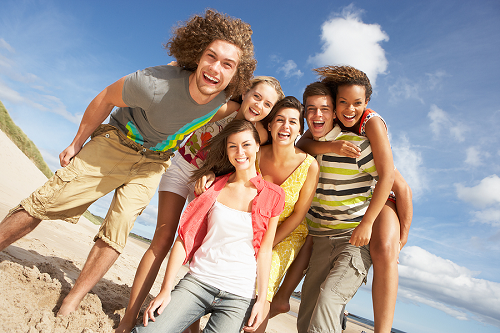 Group of teenagers is spending the day at a beach.